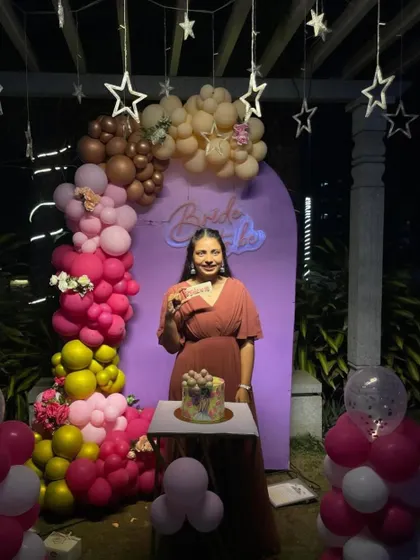 The bride-to-be enjoying her party in front of the custom decoration I designed for her special night.