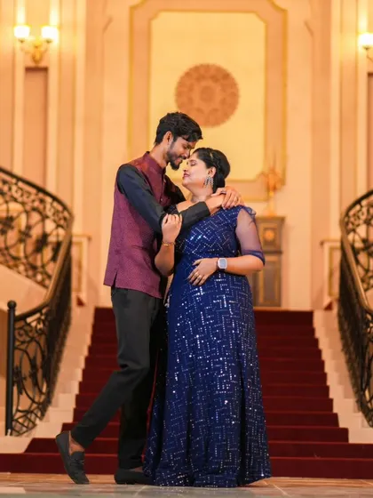 A grand staircase shot in a luxurious location. The formal outfits and elegant setting make for a truly cinematic pre-wedding photo.