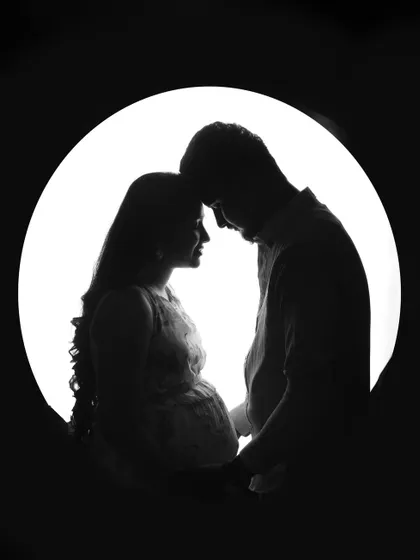 A simple and powerful silhouette of an expecting couple. This artistic black and white portrait focuses on your connection and the beautiful shape of the baby bump, creating a timeless piece of art.