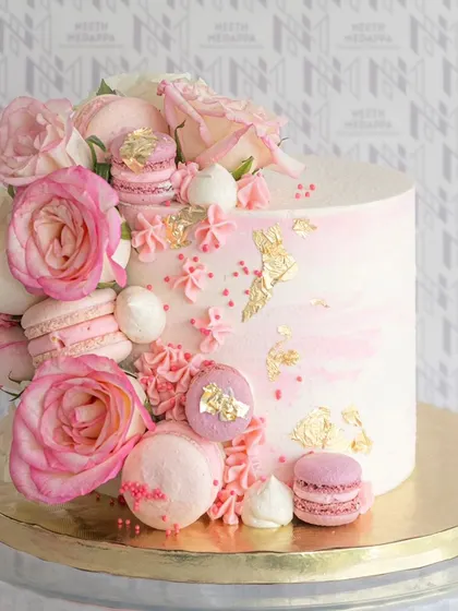 A beautiful cake where the elegance of roses meets the sweetness of macarons. The pink and gold details make it a true showpiece.
