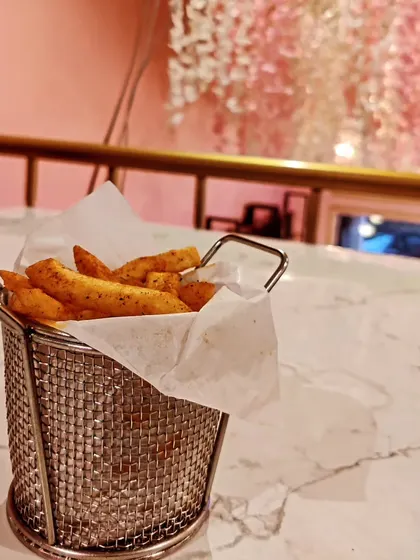 A basket of our crispy peri peri fries, perfectly seasoned for a spicy kick. This is a popular snack to enjoy any time of day at the cafe.