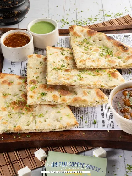 A classic North Indian meal of Chole with Naan. The bright, airy lighting gives it a clean, daytime feel, perfect for a lunch menu.