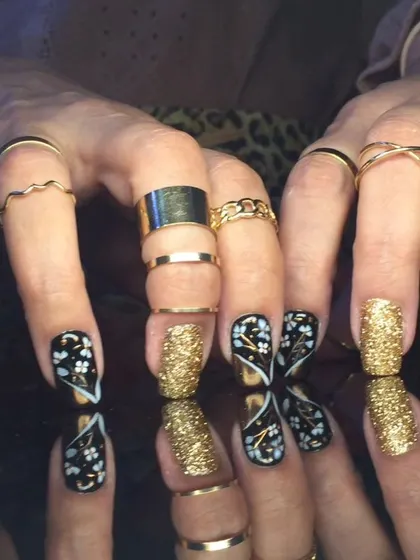 Another angle of the intricate black, white, and gold floral and glitter design.