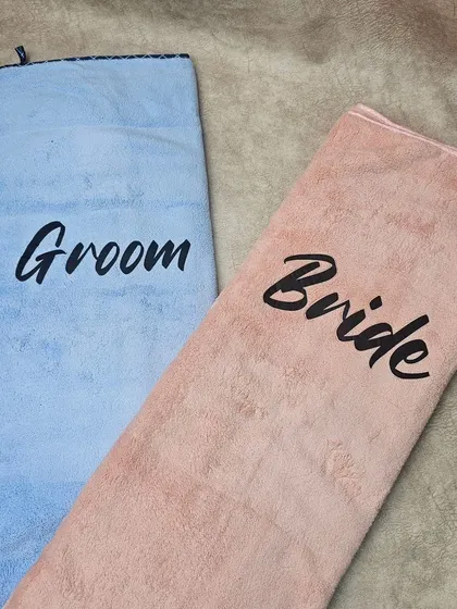 The personalized 'Bride' and 'Groom' towels displayed side-by-side. I can also customize these with different text or names upon request.
