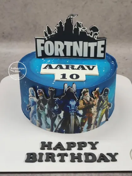 A sleek Fortnite cake for a 10th birthday. The cake is wrapped in an edible image of Fortnite characters with the game's logo on top.