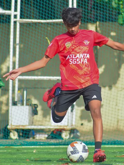 Another action shot of a player about to strike the ball, demonstrating excellent form.