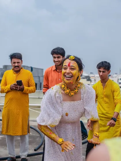 A candid photo of a bride-to-be laughing during her Haldi. We love capturing these unposed moments of pure happiness.