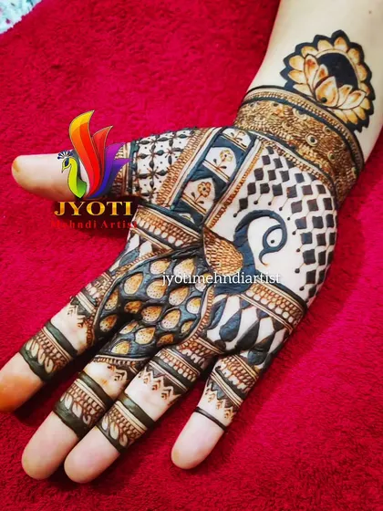 This creative Karva Chauth design features a bold peacock as the centerpiece, surrounded by intricate checkerboard patterns and fine line work.