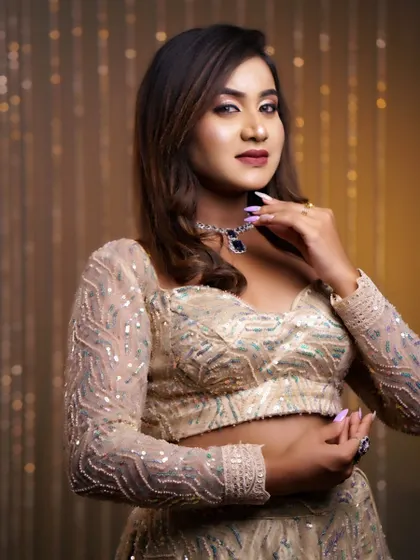 A portrait showcasing a glamorous party makeup look. The focus is on luminous skin, defined eyes, and a hairstyle with soft waves.