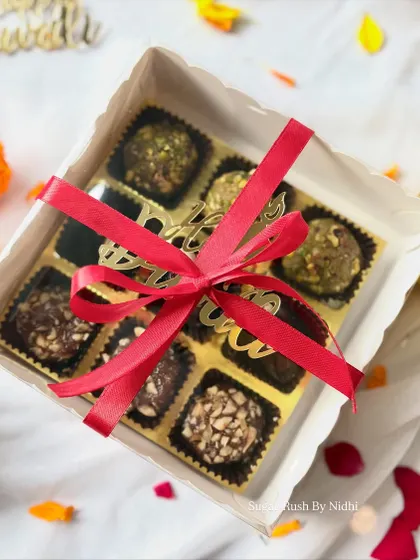 My Diwali 'Sweet Box' tied with a festive ribbon. Inside you'll find Pistachio Mafroukeh, Peanut Butter Stuffed Dates, and Hazelnut Mafroukeh.
