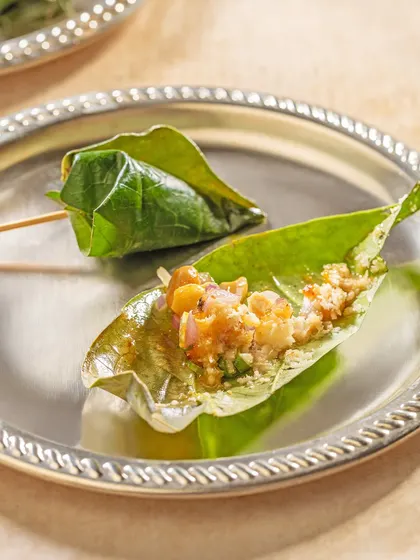 A traditional mouth freshener, served with elegance. We offer beautifully prepared paan, a betel leaf parcel filled with sweet and aromatic ingredients, as a perfect end to a grand Indian meal.
