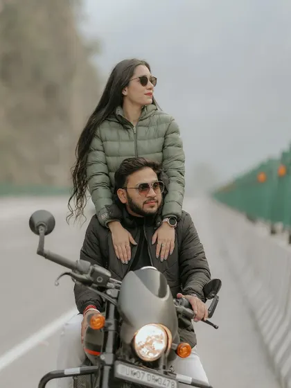 A stylish shot of the couple on a motorcycle, showcasing their cool and adventurous side during their pre-wedding session in the hills.