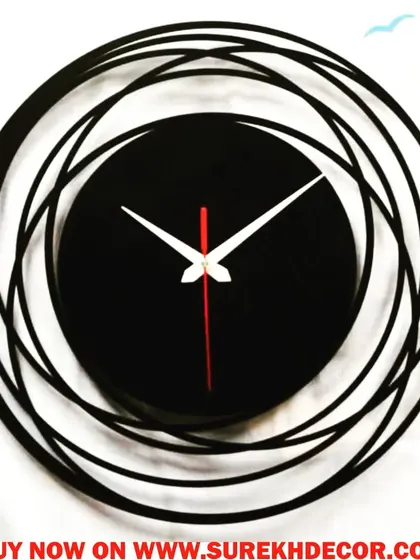 This abstract wall clock features a swirling, multi-circular frame in charcoal black. The minimalist face is centered within the dynamic design, creating a piece that feels like a modern sculpture.
