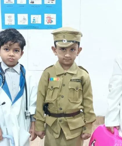Four young students dressed as doctors and a police officer, learning about the importance of these essential community roles.