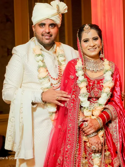 A classic wedding portrait of the couple. The bride's hand rests gently on the groom's shoulder, a simple gesture of connection and love.