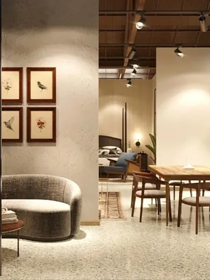 A quiet corner of the store designed as a reading nook or small seating area. The curved sofa and warm lighting create an intimate and inviting space for customers to pause and relax.