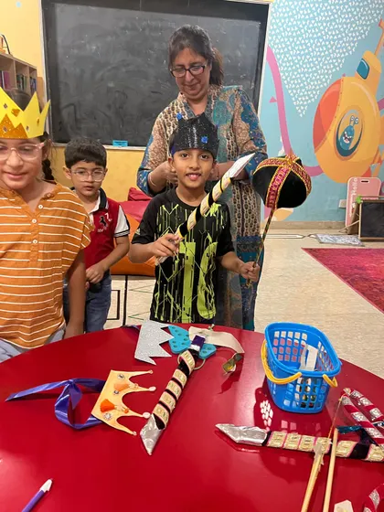 A student proudly holds his props during our Ramleela preparations. Being part of the creation process makes the performance more meaningful.