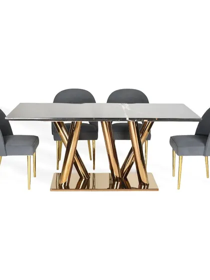The complete dining set with the black marble top table and grey suede chairs. The contrast between the dark top, gold base, and soft grey fabric creates a sophisticated and balanced composition.