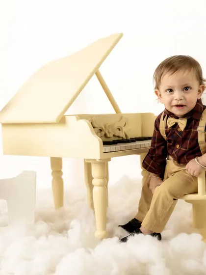 This little gentleman looks so sharp with his bow tie and suspenders for his piano-themed milestone shoot.