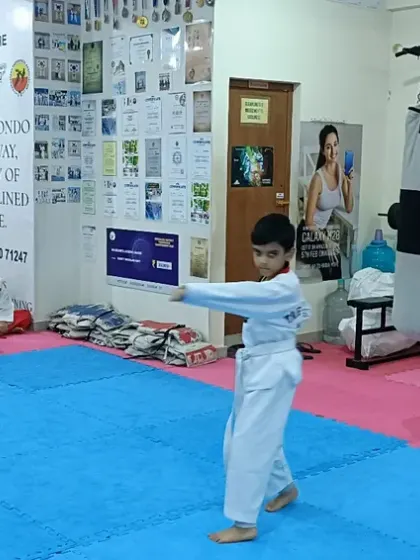 A student practices his form in front of the class.
