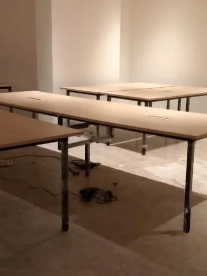 Long conference or co-working tables being assembled on-site, showcasing the simple and durable design we provide for commercial clients.