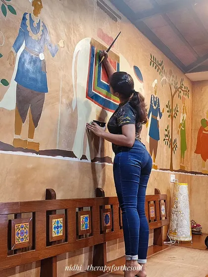 Here I am, in my element, adding the final details to the Cheriyal elephant. This is what it's all about: turning a blank wall into a story, one brushstroke at a time. It’s a physically demanding process, but the result is always worth it.