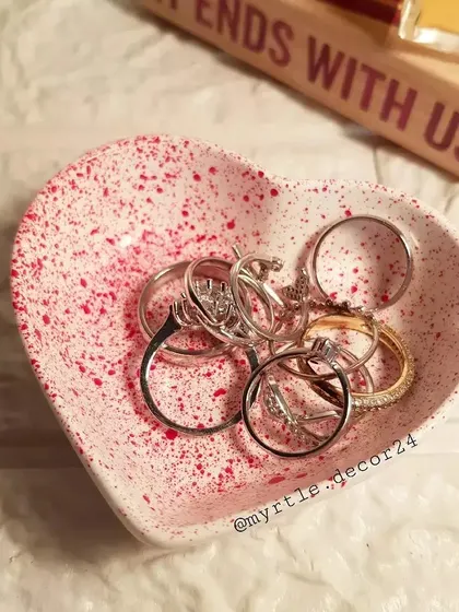 This mini heart dish is filled with rings, showing just how practical these small, decorative pieces can be for organizing your jewelry.