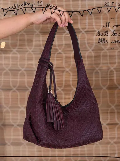 The Little Sunaina hobo bag, shown here in our All Woven Twill Bordeaux style. The entire body is hand-woven, and the handle features our signature twilling detail, making it a beautifully textured and artisanal piece.