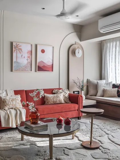 A pop of color can bring so much joy to a room. In this living space, a bold red sofa is balanced by a neutral beige palette, creating a look that is both vibrant and inviting.
