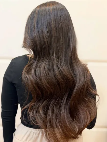 The back view of this caramel brown transformation shows how the color is seamlessly blended for a natural, sun-kissed effect.