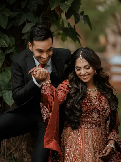 A playful and romantic moment between Sushmitha and Deepak during their reception photoshoot.