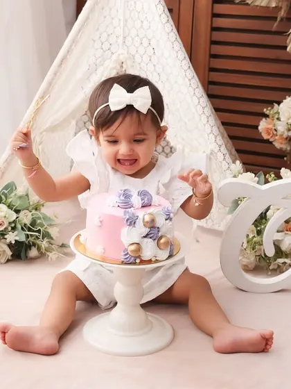 Pure excitement! The joy on her face as she gets ready to dive into her cake is priceless. My goal is to capture these expressions of pure, uninhibited happiness.