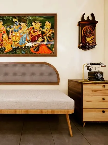 I believe in creating modern homes that still honor tradition. This space features a comfortable daybed with a traditional tufted headboard, paired with a vintage telephone and a classic Tanjore painting, blending old-world charm with contemporary comfort.