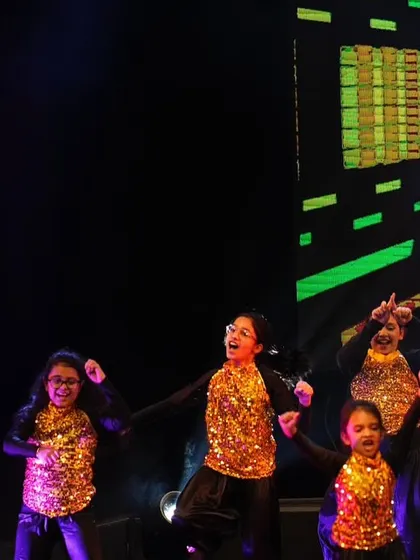 A close-up of the kids' smiling faces as they perform their freestyle hip hop number. Their joy is contagious!