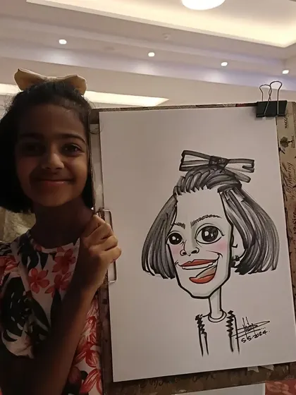 A girl with a big bow in her hair, and a caricature to match. These little details make the drawing so much more personal.