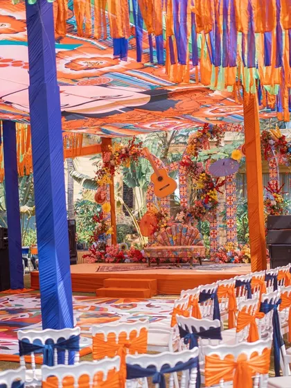 A wide view of the Mexican-themed Mehendi setup. The custom-printed ceiling, colorful drapes, and themed stage all come together to create a lively and immersive fiesta.