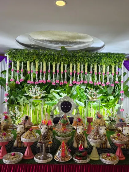 A full view of the stage with the green backdrop and pink floral accents.