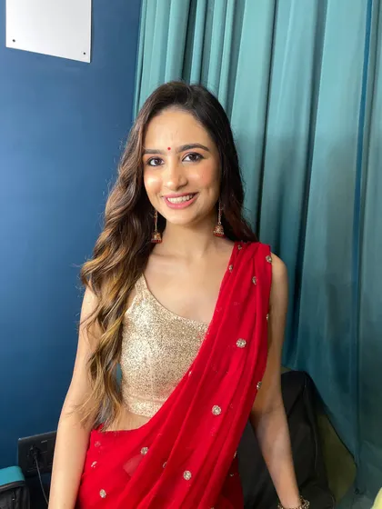 A happy, smiling shot of this beautiful client. The red saree and gold blouse are a timeless combination, and the makeup is the perfect complement.
