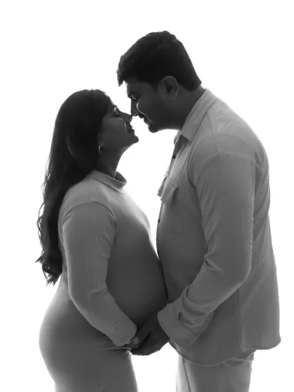 A beautiful high-contrast silhouette of a couple about to kiss. This black and white photo is romantic and artistic, focusing on their connection and excitement.