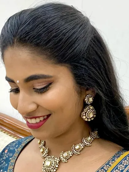 A soft, smiling portrait. The makeup is timeless and sophisticated, perfect for any wedding-related celebration.