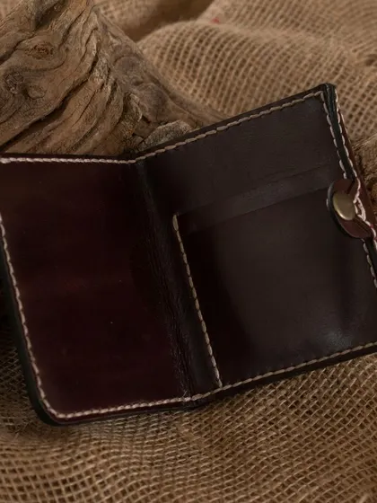 An open view of a handcrafted leather wallet, showcasing the kind of item participants can learn to make in our leather craftsmanship workshop.