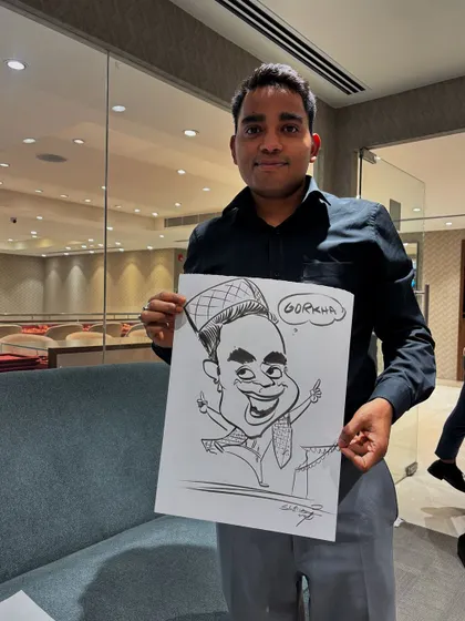 An employee at Reliance Jewels in Koramangala, proudly holding his "Gorkha" themed caricature. It's always fun to add a personal touch that reflects someone's identity.