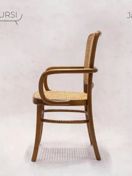 The 'Jawa' chair, a vintage classic. Its bentwood teak frame and rattan surfaces are a nod to timeless European cafe chairs, built with the durability of solid teak.