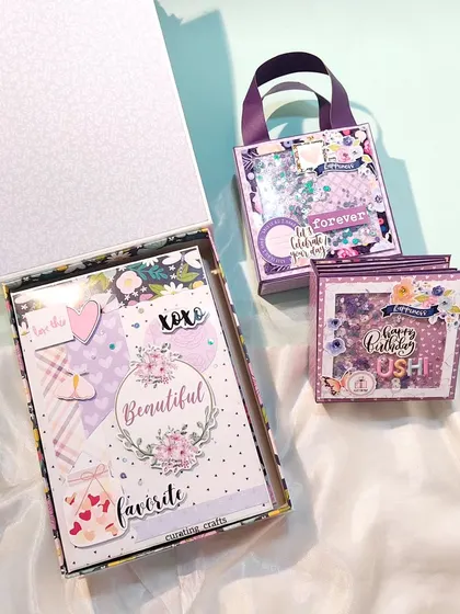 The two scrapbooks shown inside their respective gift boxes, creating a beautiful gift presentation.