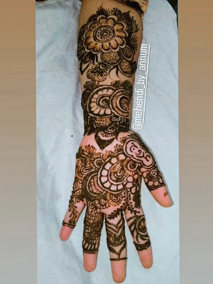 An intricate and dense bridal design for the back of the hand. This piece is filled with paisleys, swirls, and floral elements, leaving very little open space for a truly traditional and rich look.