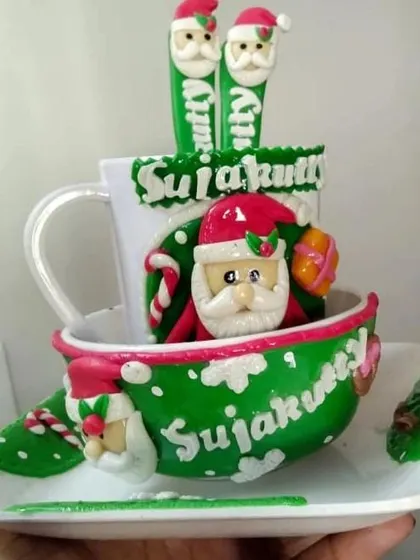 A highly detailed, custom-made Christmas mug featuring 3D clay art of Santa Claus and personalized names. This is a true collector's item.