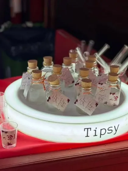Our custom alcoholic shots, served in mini glass bottles with personalized tags. This glowing display makes for an inviting and unique shot station at any event.