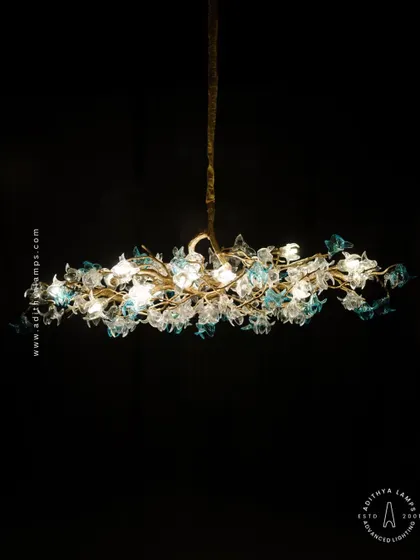 This enchanting chandelier is a bouquet of light, composed of dozens of hand-blown glass flowers in clear and soft blue hues. The intricate design creates a magical, garden-like atmosphere, perfect for a romantic bedroom or elegant dining space.