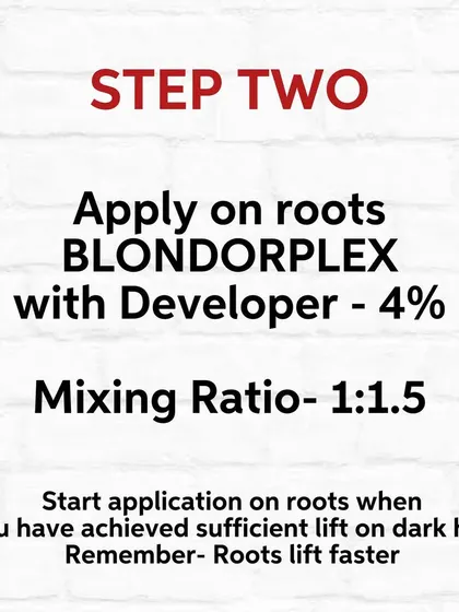 Step Two of lightening. Once the mid-lengths have lifted, I apply a new mix to the root area, which lifts faster.