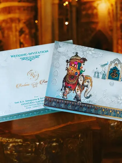 Indulge in royalty with our exquisite royal Indian wedding invitations. This design features a majestic elephant carrying a howdah, set against a beautiful palace backdrop.